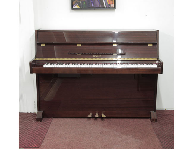 Pre-owned, Royale VS-41 upright piano with a mahogany gloss case. Piano has an eighty-eight note keyboard and three pedals. 