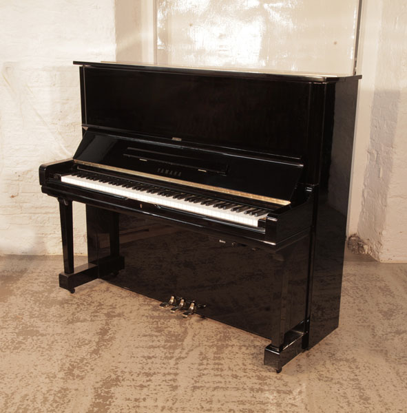 Reconditioned, 1974, Yamaha U1 upright piano for sale with a black case and brass fittings. Piano has an eighty-eight note keyboard and three pedals.  