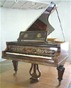 An art cased Gebr�der Knake Grand  inlaid with brass, pewter and mother of pearl. Case is in excellent condition. Action needs overhauling.