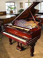 An 1889, Steinway Model B grand piano with a polished, rosewood case.