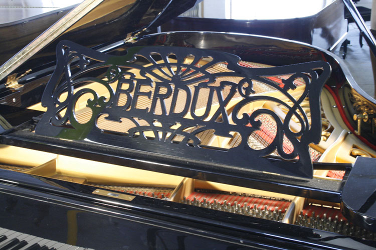 Berdux openwork music desk in a sinuous design with central Berdux logo