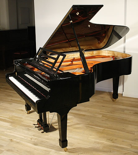 Feurich concert grand Piano for sale with a black case.