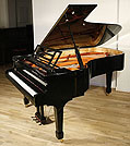 Piano for sale. A Feurich concert grand piano with a black case and polyester finish. 