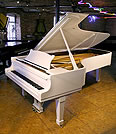 Piano for sale. A Steinway Model D concert grand piano with a white case.