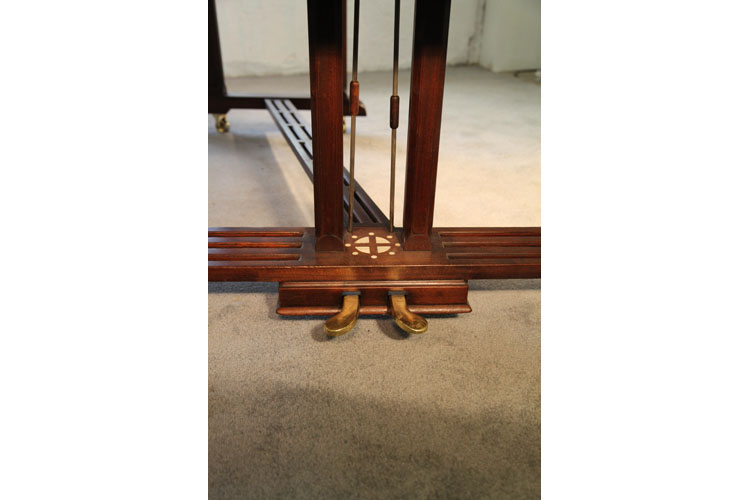 The two-pedal piano lyre features an inlaid circle with central cross motif and is attached to a slatted cross stretcher