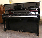 Piano for sale. A Feurich Model 122 upright piano with a black case.