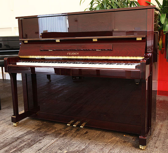 Brand New, Feurich Model 122 upright Piano for sale with a mahogany case.