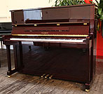 Piano for sale. A Feurich Model 122 upright piano with a mahogany case.