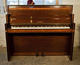 Piano for sale. An art-deco Waldberg upright piano with a mahogany case