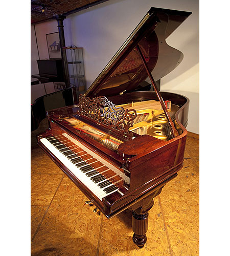 A 1900 Steinway Model A grand piano with a rosewood case and fluted, barrel legs. Piano has an eighty-five note keyboard and a two-pedal lyre. 