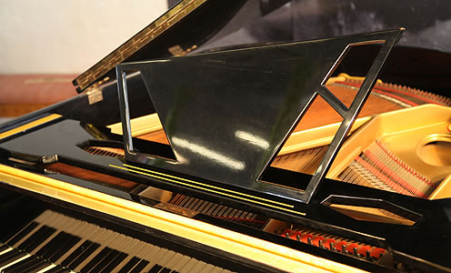 Zimmermann asymmetric piano music desk with geometric cut-outs.