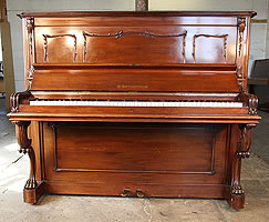 An 1890, Bechstein Model III upright piano with a walnut case and claw foot legs