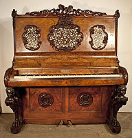Ernst Rowold Upright Piano For Sale with an Ornately Carved, Black Forest Style Case. Cabinet features  legs carved with sphinx, eagle and ornate fretwork panels with carved floral borders