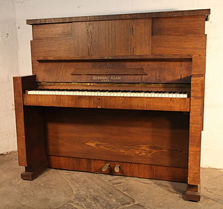 A Gerhard Adam upright piano with a Modernist almost Brutalist style oak case