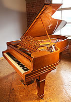 A 1900, Steinway Model B grand piano with a satinwood case with boxwood stringing detail.