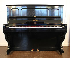 A 1905, Steinway vertegrand piano with a polished, black case and etched front panel.