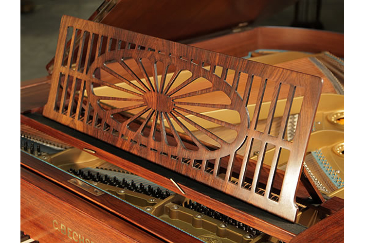 Bechstein  piano music desk  in a slatted openwork design with central sunburst motif