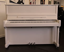 Feurich 122 upright piano with a white case and chrome fittings