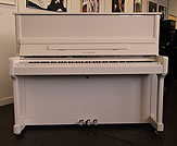 Piano for sale. A Feurich Model 122 upright piano with a white case.