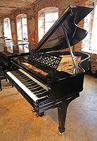 A rebuilt, 1911, Steinway Model O grand piano with a black case and spade legs
