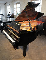 A  Yamaha C7 grand piano with a black case
