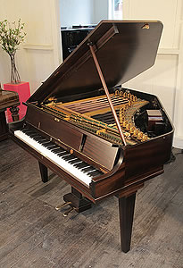 A Neo-Bechstein electric grand piano with a mahogany case. The first electric grand piano