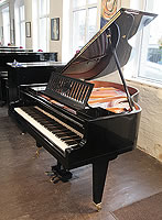 A 1936, Bosendorfer baby grand piano for sale with a black case, slatted music desk and square, tapered legs