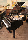 Piano for sale. A Feurich Model 178 Professional grand piano with a black case, openwork music desk and gun metal frame  