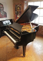 A 1972, Steinway Model A grand piano with a black case and spade legs.