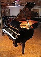 A 2006, Steinway Model B grand piano with a black case and spade legs.