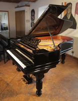 An 1886, Steinway Model B grand piano with a black case, filigree music desk and fluted, barrel legs