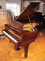 A 1925, Steinway Model B grand piano with a fiddleback mahogany case and spade legs