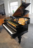 A restored, 1924, Bechstein Model A1 grand piano with a black case and turned, facetted legs
