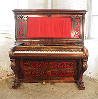 A Collard and Collard upright piano with a rosewood case. Cabinet features ornate, filigree panels with red silk backing and carved, cabriole legs