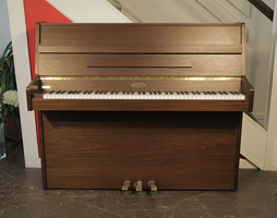 A 1990, Kemble upright piano with a mahogany case. Piano has a Langer 100 action and three pedals 