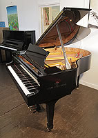 A brand new, Steinberg WS-T166 grand piano with a black case and brass fittings. The instrument features the best in German design