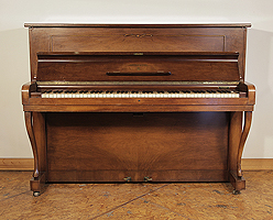 A 1954, Steinway Model Z upright piano with a mirrored, walnut case and cabriole legs. 