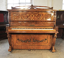 A Waddington upright piano for sale with an Art Nouveau style, walnut case. Cabinet features inlaid panels of fuchsias with sinuous tendrils and carvings of foliage and flowers.