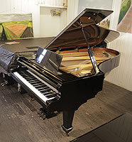 A 1978, Danemann concert grand piano with a black case and spade legs