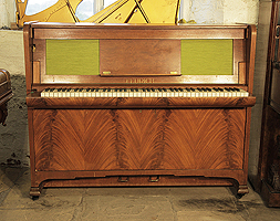 A 1934, Feurich yacht upright piano with a flame mahogany case and folding keyboard. Piano is slim in profile to fit a smaller space.