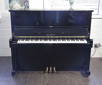 A 1991, Kawai SU-2L upright piano with a black case and polyester finish