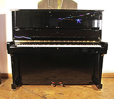 A 1995, Steinway Model K upright piano with a black case and brass fittings