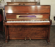 A Welmar upright piano with a flame mahogany case