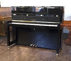 A Brand new, Bauhaus style, Feurich Model 115 Premiere upright piano with a black case and polyester finish