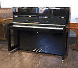 Piano for sale. A Brand new, Bauhaus style, Feurich Model 115 Premiere upright piano with a black case and polyester finish.
