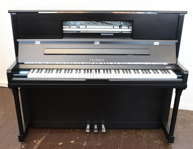 Brand new, Feurich Model 123 upright piano for sale with a satin, black case, LED lighting and chrome fittings. Piano features a high speed KAMM action that allows for extremely fast repetition. Piano has an eighty-eight note keyboard and three pedals.