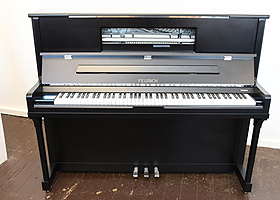 A Brand New Feurich Model 123 upright piano with a satin, black case, LED Lighting and chrome fittings. Piano features a high speed KAMM action that allows for extremely fast repetition