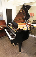 A 2017, Kawai GM10 baby grand piano for sale with a black case and square, tapered legs