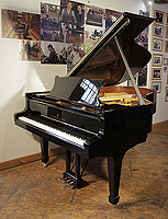A 1970 Steinway Model A grand piano with a black case and spade legs