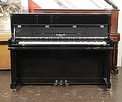 A brand new, Besbrode SU112 upright piano with a black case and chrome fittings